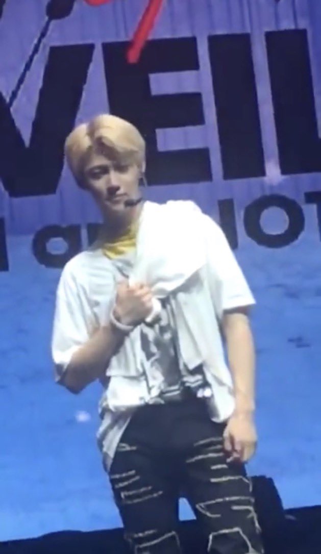 Felix clutching his heart after seeing a sign that’s says “Bisexuals Love Felix”