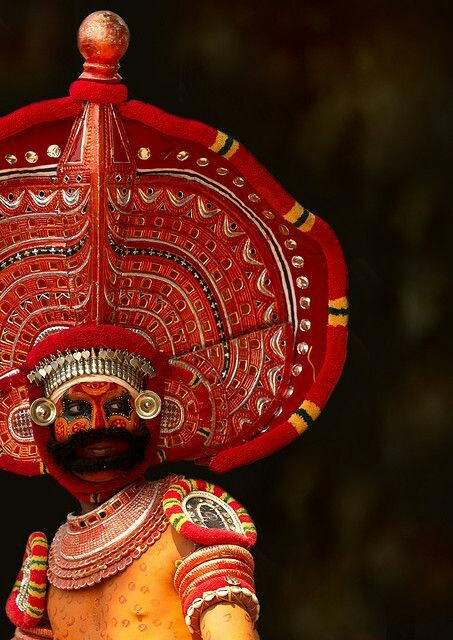 Theyyam is often performed by men and they themselves enact the female roles also by wearing elaborate make-up and costumes. The facial makeup is so intricate that the artist has to lie on the floor for hours while the designs are painted on their faces.