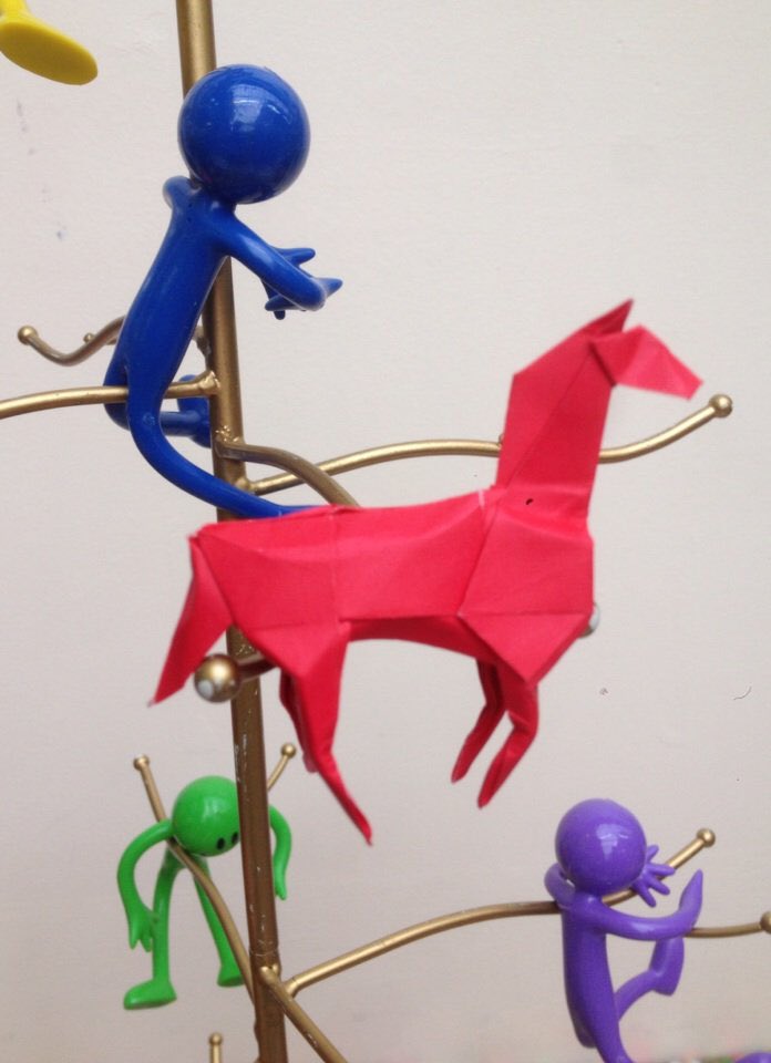 One student sitting a short distance away listened to the conversations I was away while working on something in her hands. When I packed up at the end she came and put a little red origami horse into the metal tree I used for display. 5/