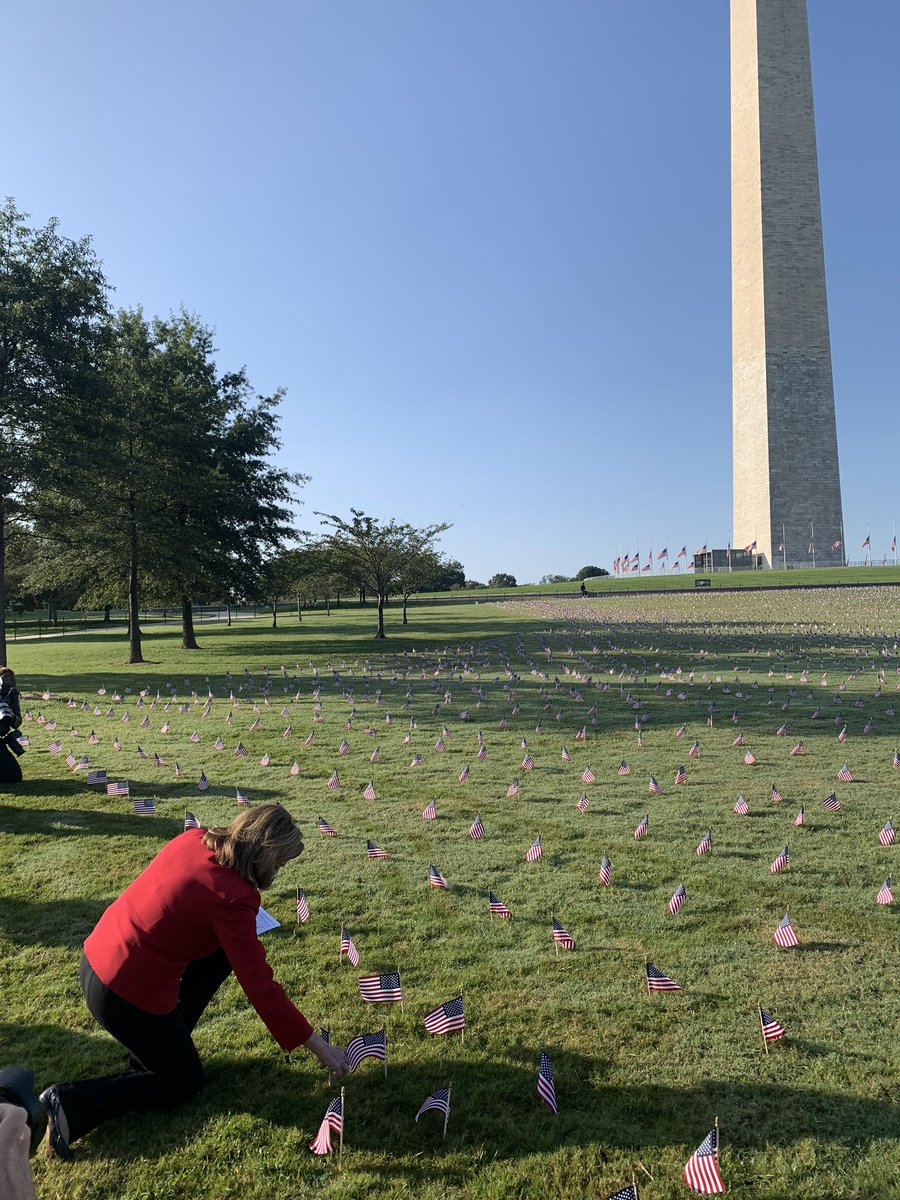 PELOSI places a flag outside the Washington Monument, marking the COVID-19 losses.