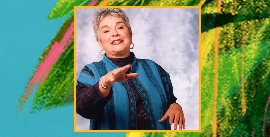 Storyteller Olga Loya in front of a blue background with leaves illustrated