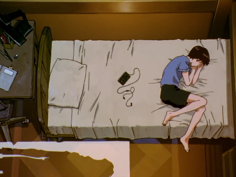 Screencap from Evangelion. Shinji Ikari curled nearly into a fetal position in bed, not using his pillow or his headphones.