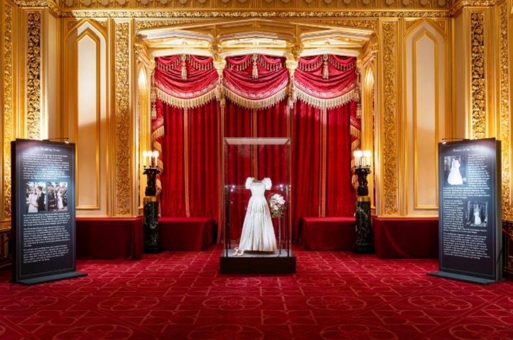 A first look at Princess Beatrice's wedding dress on display in the State Dining Room at Windsor Castle. Visitors will be able to see it from tomorrow and purchase commemorative items to mark the wedding, which took place in July.