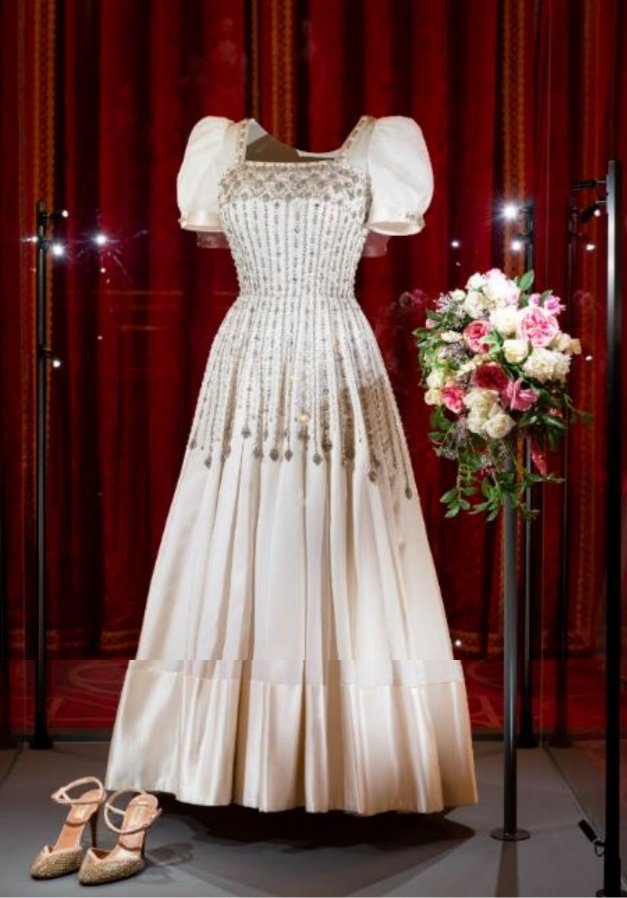 A first look at Princess Beatrice's wedding dress on display in the State Dining Room at Windsor Castle. Visitors will be able to see it from tomorrow and purchase commemorative items to mark the wedding, which took place in July.