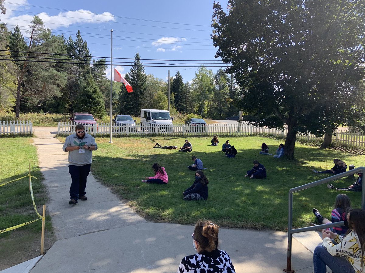 Listening to teacher read while we sit under a tree - ahhh outdoor learning#tldsb #@whahn96 #wilberrocks