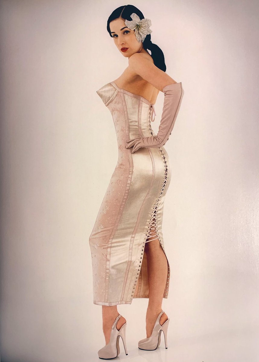 While he showed his first collection in 76 he didn’t formally launch his house til 1982 in that collection for 1983 we see the first corset gown. Here’s another view of it on Dita Von Teese and her notes on it. Note the pointed cone bra detail of a 1950s Bullet Bra.