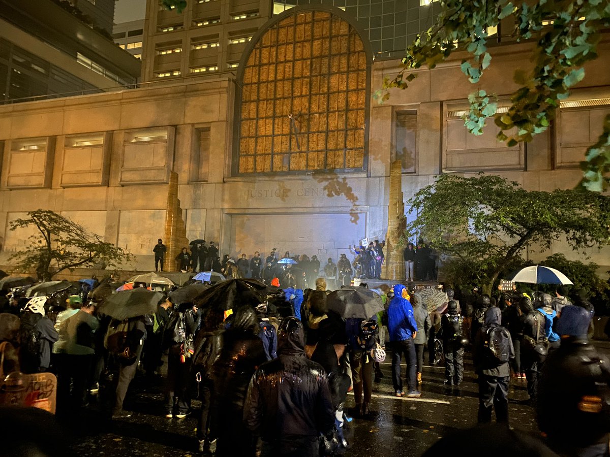 Protestors are standing in the rain