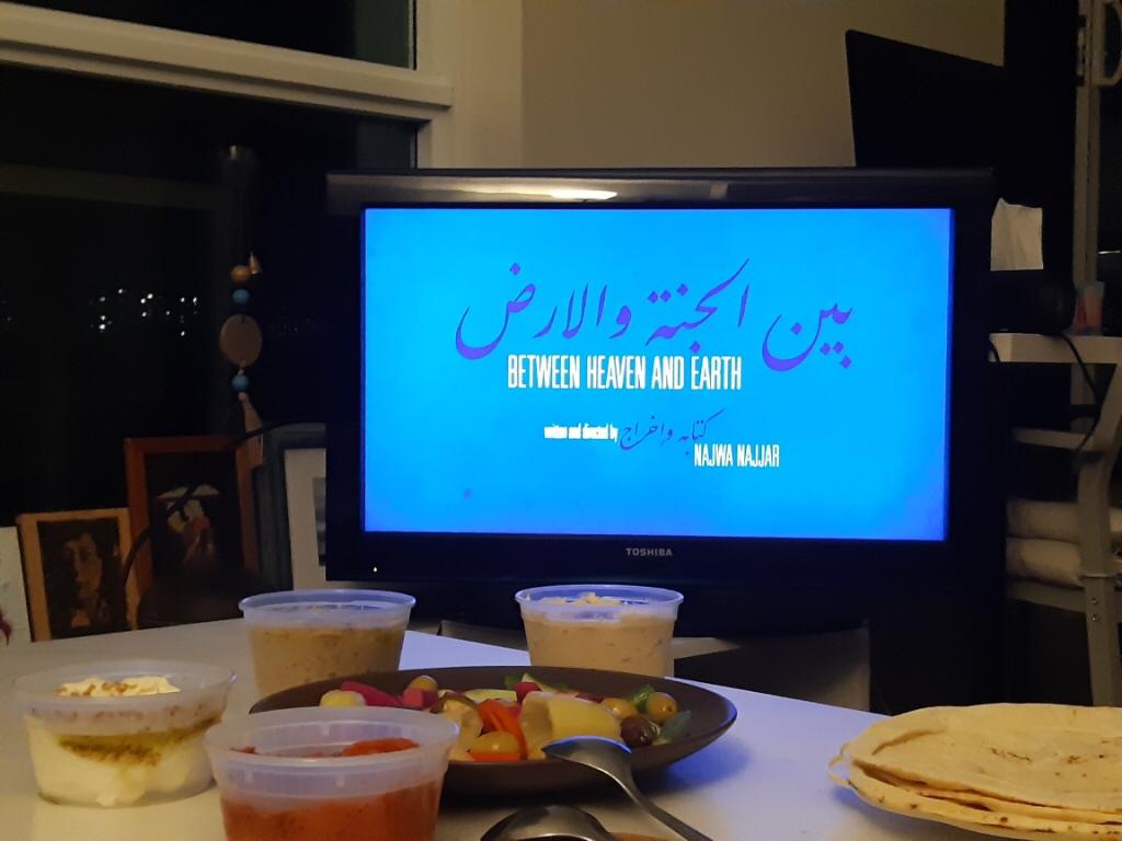 TPFF's tweet photo. This is how TPFF is enjoying opening night. Ordered dinner from Sahtain at Home parter restaurant and watching the Canadian premiere of @NajwaNajjar film Between Heaven and Earth #tpff2020 https://t.co/P9HBRifEFX