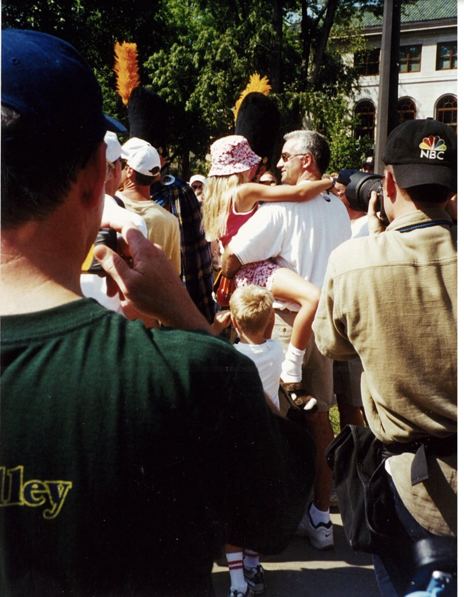 I need everyone's help tracking down the man pictured here in a white shirt & holding his daughter. He is a  @notredame alum & former Irish Guardsman. Photo was taken during  @notredame's season opener vs  @TAMU in Sept 2000. For 20 years, I have wanted to meet & thank him. 2/