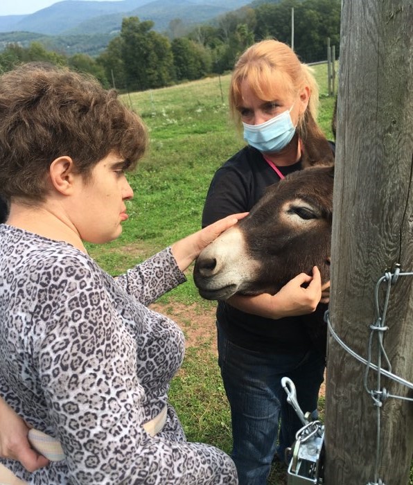 TCFDiscovery's tweet photo. #TCFD residents paid a visit to #SweetHill farm to lend a helping hand at collecting eggs, visit w/our beloved donkeys, & to get a game of checkers going! Fun fact: the group has also been learning how to use a solar wax melter to melt down bees wax used to make lip balm! https://t.co/uwLWHLzRrJ