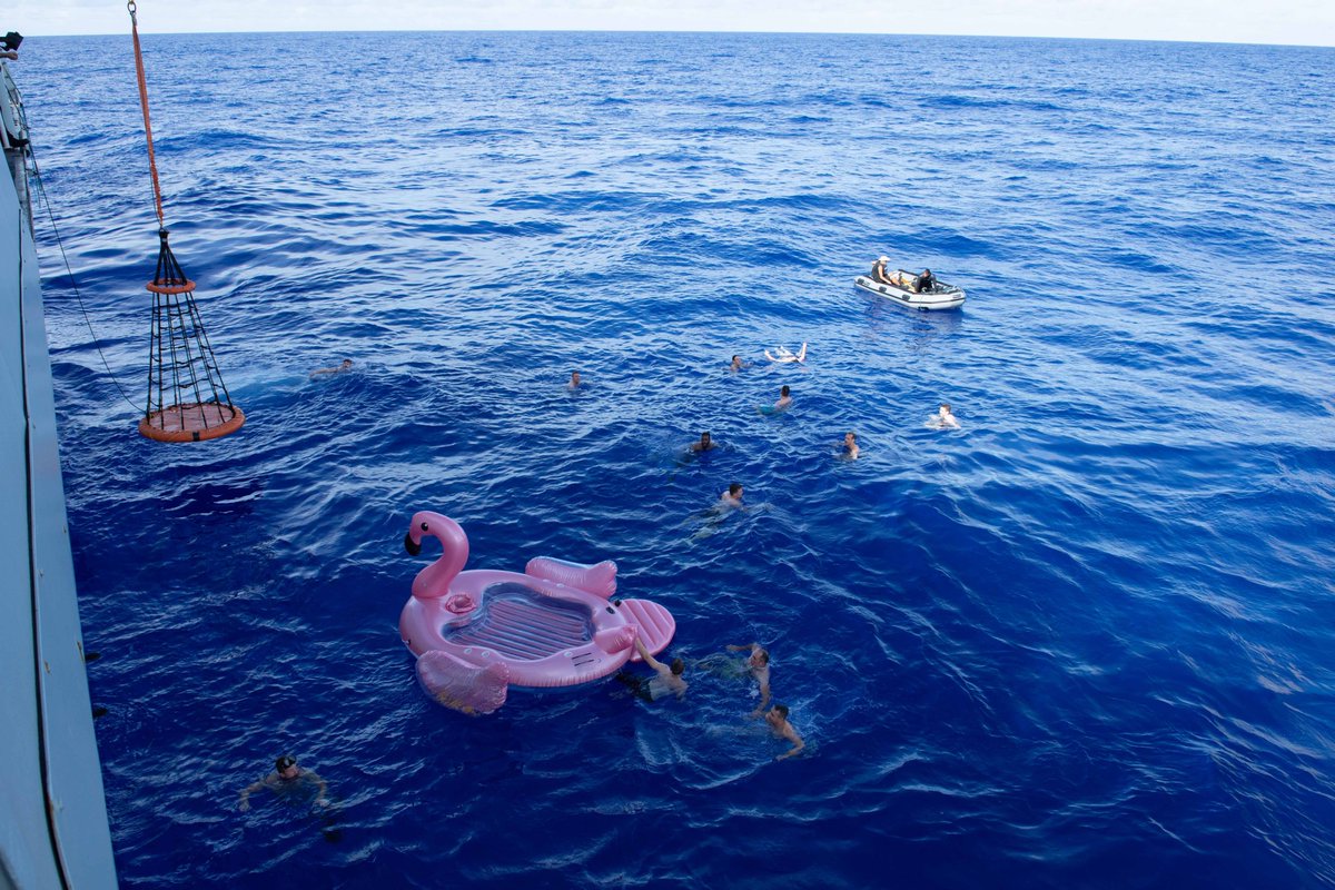 HMCSWinnipeg's tweet photo. After close to two months at sea and great work accomplished, with more work to do as we continue with our deployment, the ship was treated to something very special: 

A SWIMEX! 🏊‍♀️🏊🏊‍♂️

Our newest member of the ship's company - our pink flamingo float - even came out for a swim! https://t.co/DJ5TDszDIp