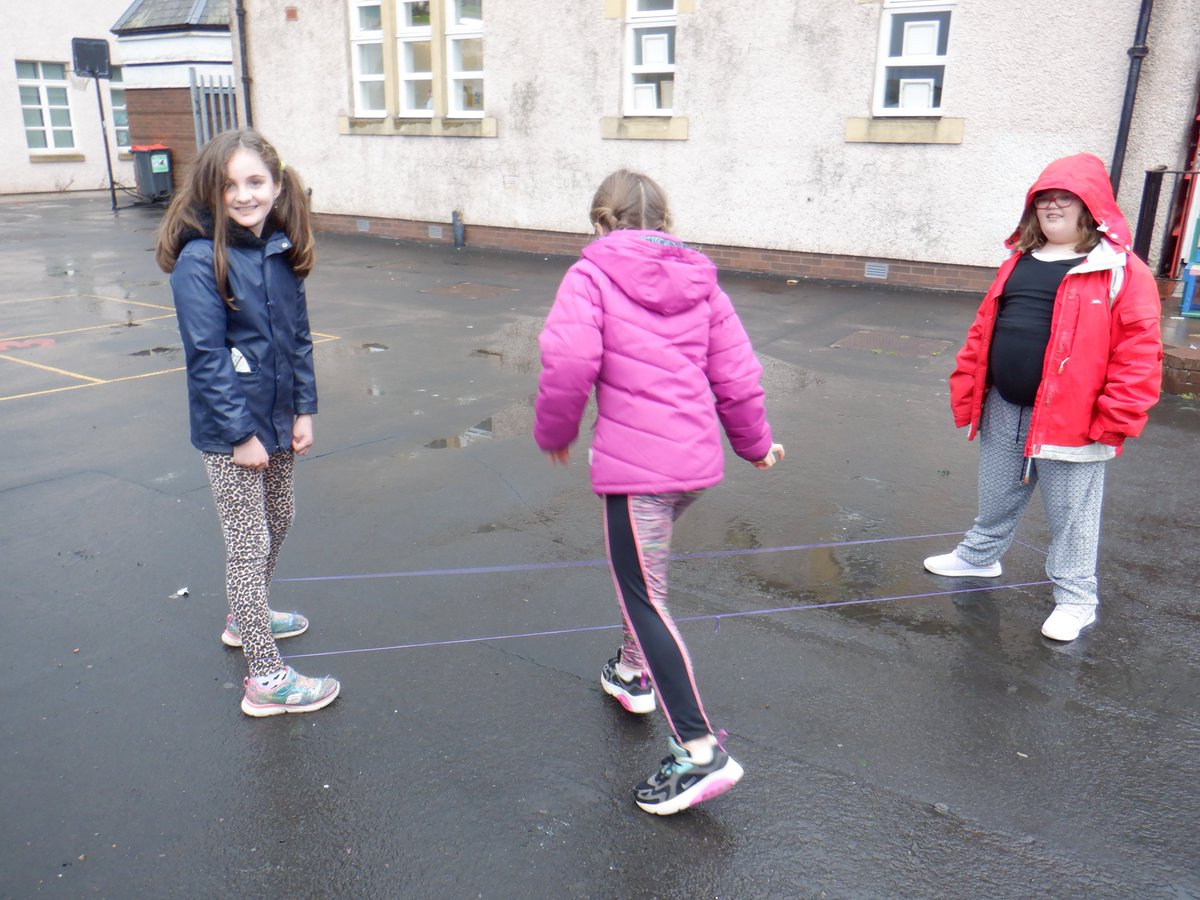 EastLintonPS's tweet photo. Despite the weather P4 got outside this week to try out a traditional playground game of elastics, it proved to be very popular, lots of routines to try.  We also made 100 square games in our numeracy lessons. #playgroundgames #chineseskipping #100square https://t.co/fGJCfahmYc