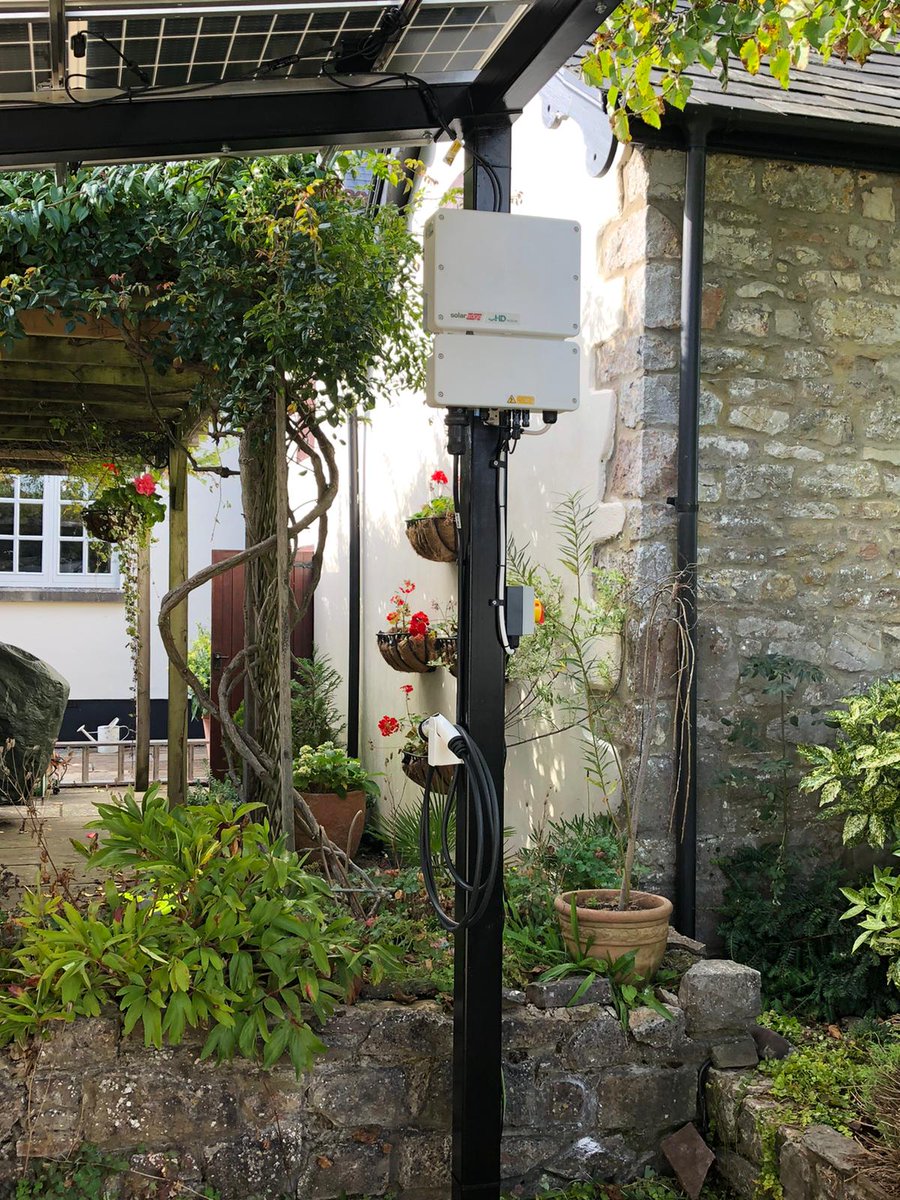 SunlightFuture's tweet image. A busy week ends with this beautiful custom solar car port. Built with @SolarEdgePV's EV-charger integrated inverter &amp;amp; 5.6kW of bifacial panels capable of absorbing sunlight bouncing off the shiny @Jaguar #ipace. Across the garden in an old dovecote a @Tesla #powerwall powers on!
