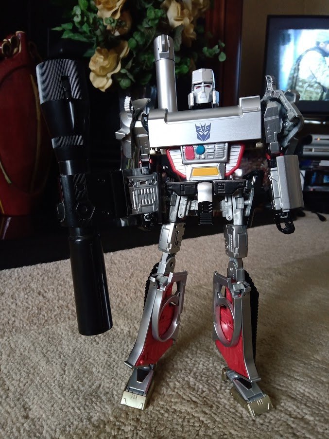 Masterpiece MP-05 Megatron - £40Typical scuffs to silver paint and rust on die-cast parts, inc. pin in mace, which has discoloured surrounding plastic. Right shoulder is loose; can't hold up weight of cannon. Small black clip from left hip-plate is broken off and not present.