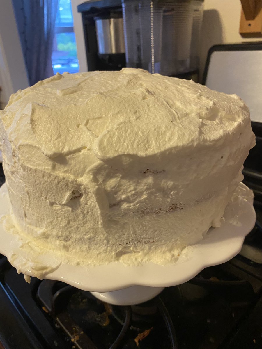 Now the rest of the plain whipped cream is spread over the cake and domed on top.