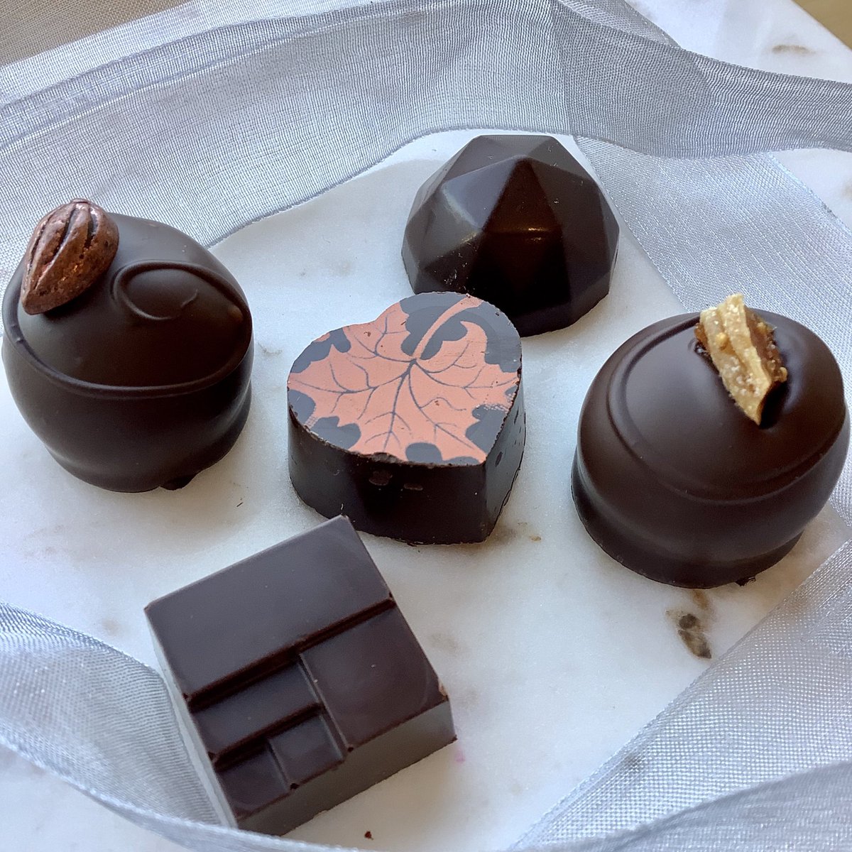 “I had to touch them all for these photos, guess I’ll have to eat them!” . . . Get yours today! 🧃Apple Cider, 🇪🇨Colombian Single Origin, 🌰Hazelnut Praline, 🍫Four Spice and 🤩Fig . . . Reminder: You can place and pick up orders on Satur-Yay! 11a-3p 😊