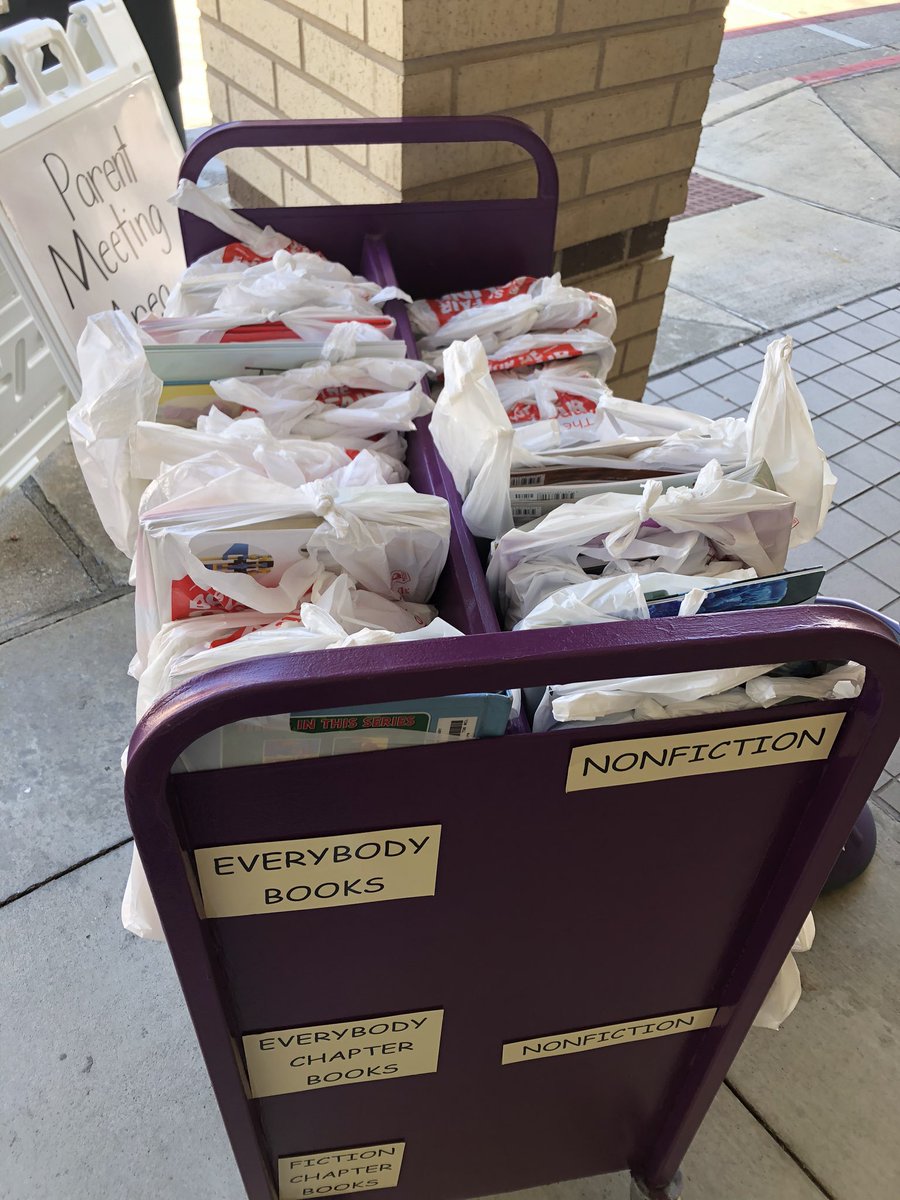 Library books on one side and bookfair books on the other! Curbside from 1:00-2:00 walk, run, or drive we are here!