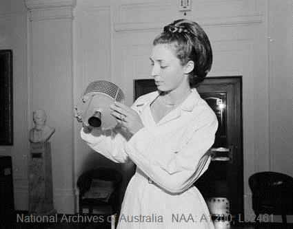 Helen Pozhidajev demonstrates a model of a communications satellite (maybe a Syncom?) in Parliament House, Canberra, 1965 (Australian News and Information Bureau, photographer W Pedersen)  #Space4Women  #womenwithsatellites