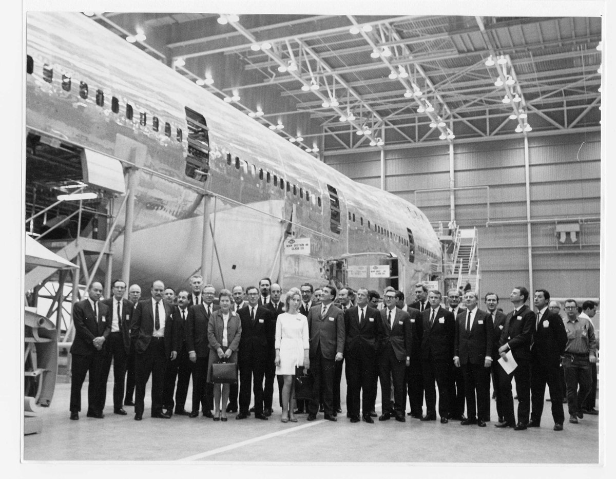 0wl's tweet image. Lurking in lockdown I missed the last takeoff of the first giant of the skies, the once astonishing 747.  Here I am, the woman in white at the Boeing works in Seattle, gathering material for the launch literature. 
#Boeing747 #BOAC #valeriebeeby