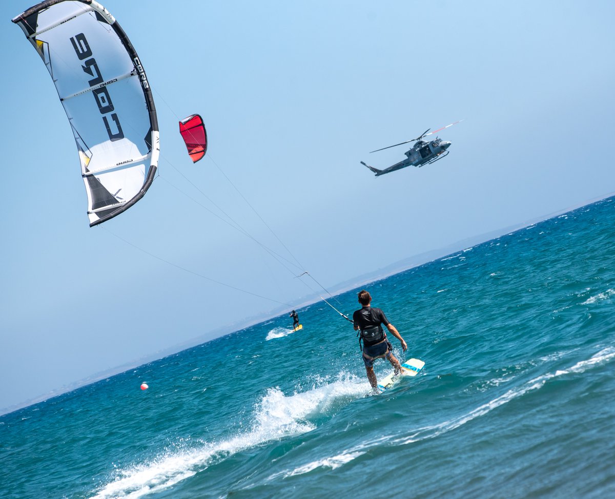 A kite surfer enjoying the waves off the coast of @bfcyprus  as an @RoyalAirForce #84Squadron Search & Rescue helicopter flies overhead. @RAFAkrotiri #Cyprus #TheBases @UKinCyprus