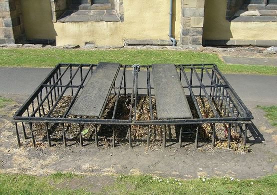 (9/11) Mortsafes could vary in design. Some consisted of heavy iron rods and plates, which were then padlocked together for extra protection. Two sets of keys were needed to unlock these types of mortsafes, like the one pictured here in Greyfriars Kirkyard, Edinburgh.