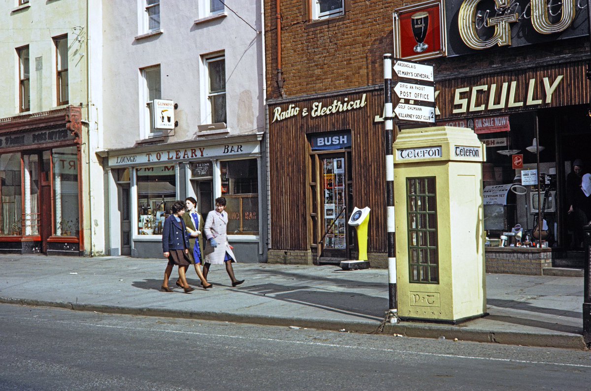 This one, another Forman, may well be of Killarney. Note the outdoor weighing scales. The other facet of these images are so many unique shop signs. It’s a pity so many have gone. Can anyone confirm the street?