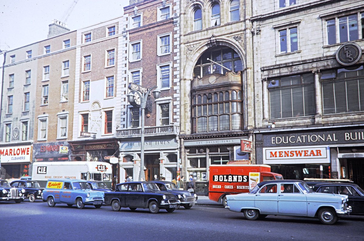 This is Westmorland St in Dublin, I think (based on the EBS). That oriel window is still there but the surrounds are an anonymous modern office block. The Bolands van & CIE freight services are fascinating. A Forman photo.