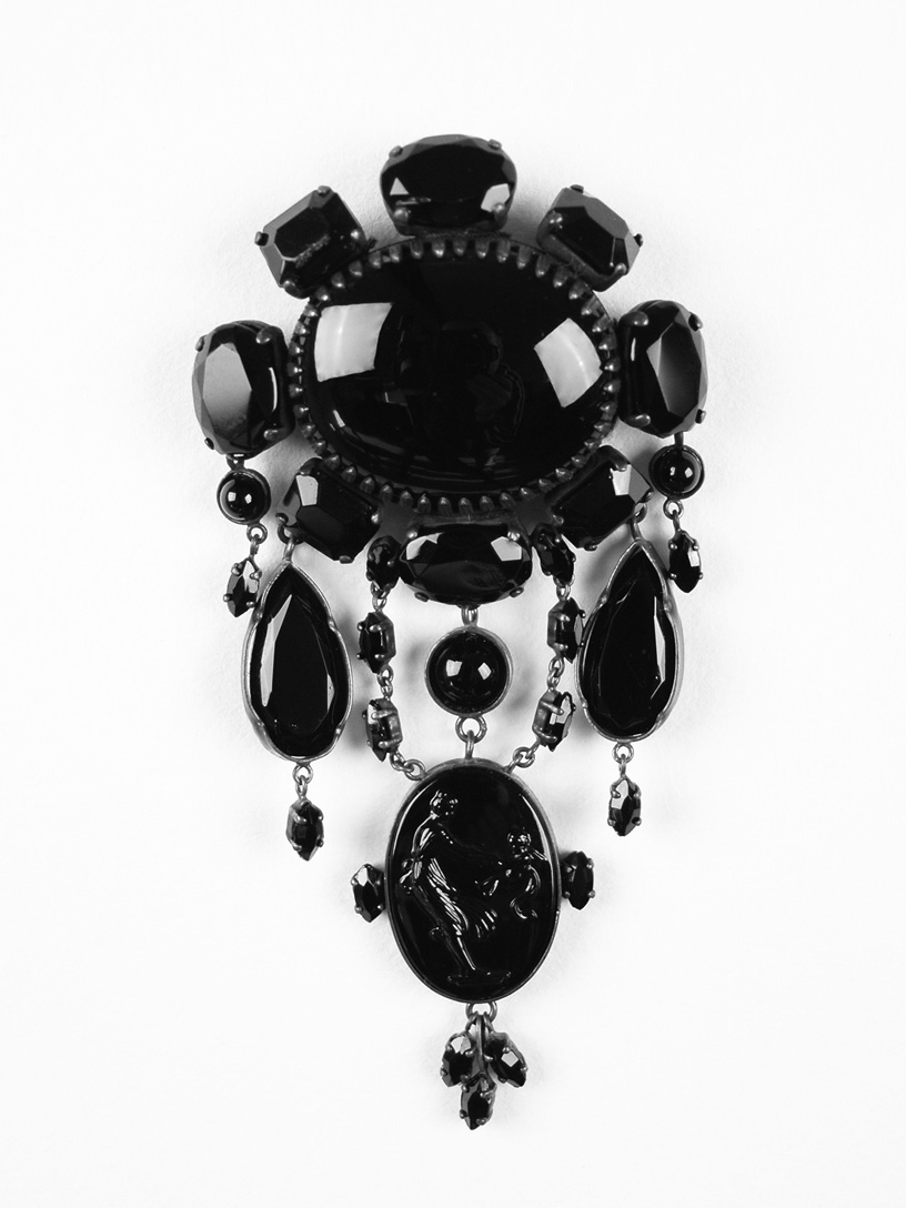 The latter part of the 1800s saw a market erupt for black glass mourning jewelry for the middle classes who could not afford the precious jet beads.