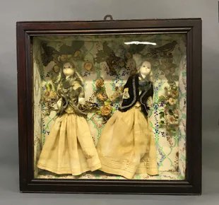 The dolls were usually left at the child& #39;s grave site, but some families would keep them in the home as a memento - in a small glass coffin, a frame, or even a crib.