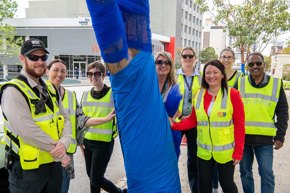 CityofPerth's tweet photo. To encourage Western Australians to speak up about mental health, the #CityOfPerth parking team and Australian Federal Police (AFP) staff took part in the #BlueTreeProject, wrapping trees in blue at the AFP Building and in CPP carparks. #MentalHealthWeek https://t.co/51FetFO3by