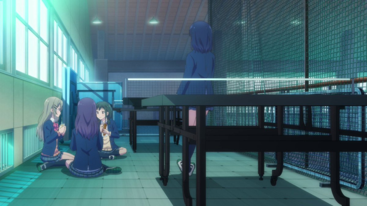 This divide is shown more by having the edge of the table create an almost symmetrical wall between Adachi and the group. Also, having Adachi be framed on her own shows he she feels separated from everyone else.