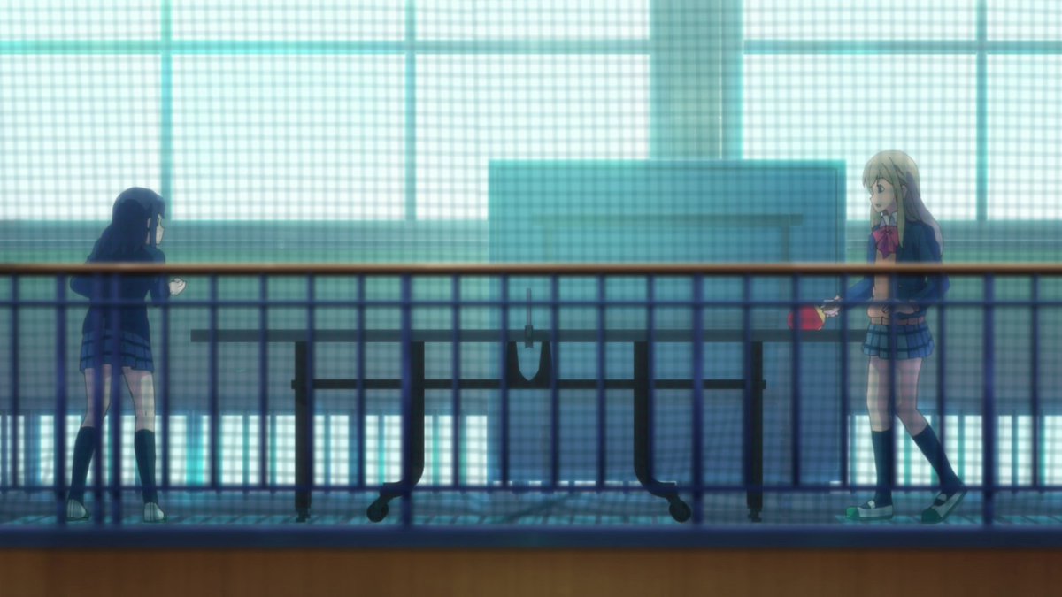 The audience can immediately identify that these two characters feel trapped in one way or another. The netting of the fence reinforces this idea, but the fact that both of them are behind this netting, happily playing ping pong, means they find solace in each other.
