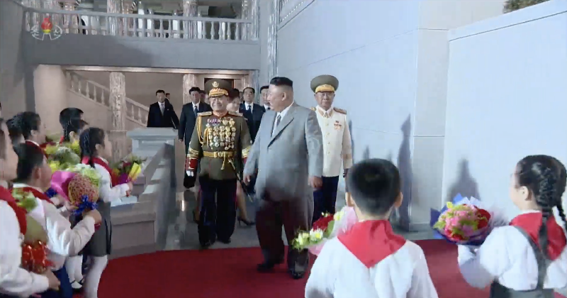 There’s Kim Jong Un—wearing a grey, western-style suit.