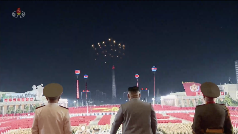 KJU watches as MiG-29s release flares over KIS Square.