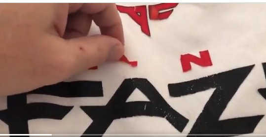 Look at how the red ATLANTA peeled up, this very likely is a heat transfer gone wrong. Heat Transfers are just like you do at home with your iron, but with a much bigger heat press and specific instructions on how long/hot to hold the press. They just didn't follow directions 5/?