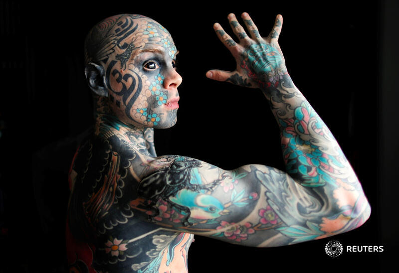 Reuters's tweet photo. A schoolteacher whose body, face and tongue are covered in tattoos and who has had the whites of his eyes surgically turned black said he was prevented from teaching at a French kindergarten after a parent complained he scared their child https://t.co/HVOQx8bQBO https://t.co/NM31rhz98b
