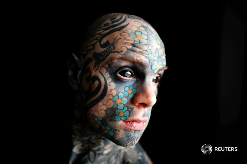 Reuters's tweet photo. A schoolteacher whose body, face and tongue are covered in tattoos and who has had the whites of his eyes surgically turned black said he was prevented from teaching at a French kindergarten after a parent complained he scared their child https://t.co/HVOQx8bQBO https://t.co/NM31rhz98b