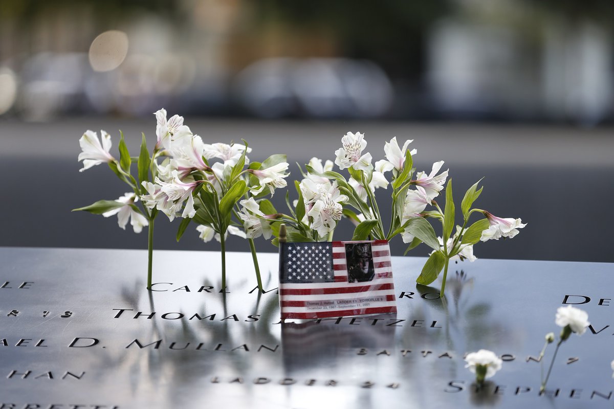 Flower tributes were left on the South Pool’s S-17 parapet. #911Memorial