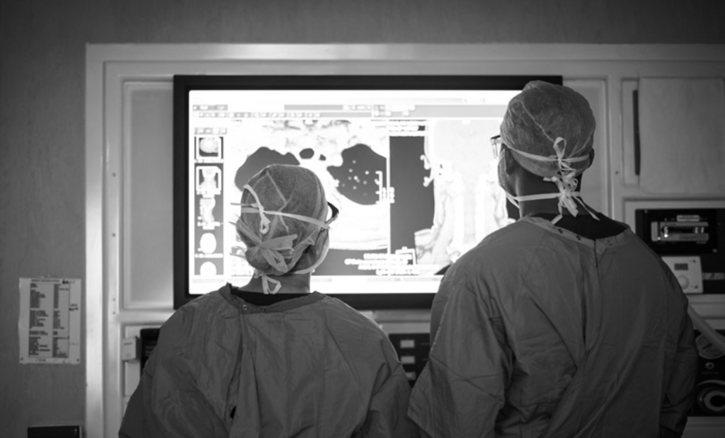 2 medical providers looking at medical images