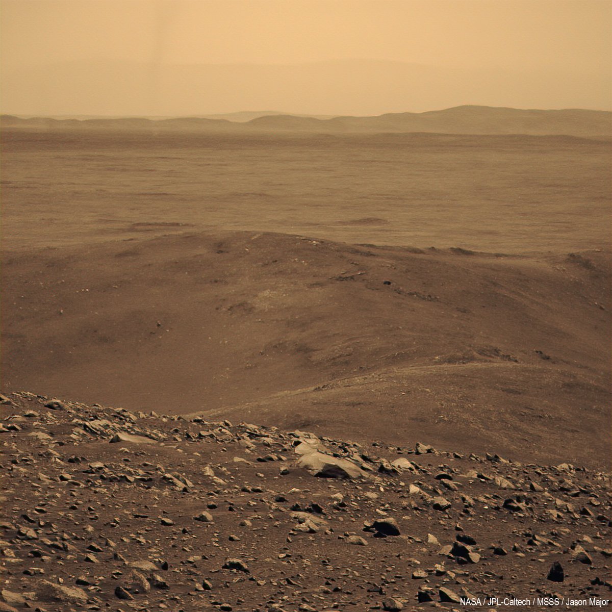 Here's a view captured by NASA's Spirit rover's panoramic camera on September 30, 2005 from atop "Husband Hill" in Gusev Crater. This is a colored monochrome image, the faint vertical blur at upper left is a dust devil in the distance. (Spirit saw a few from that vantage point.)