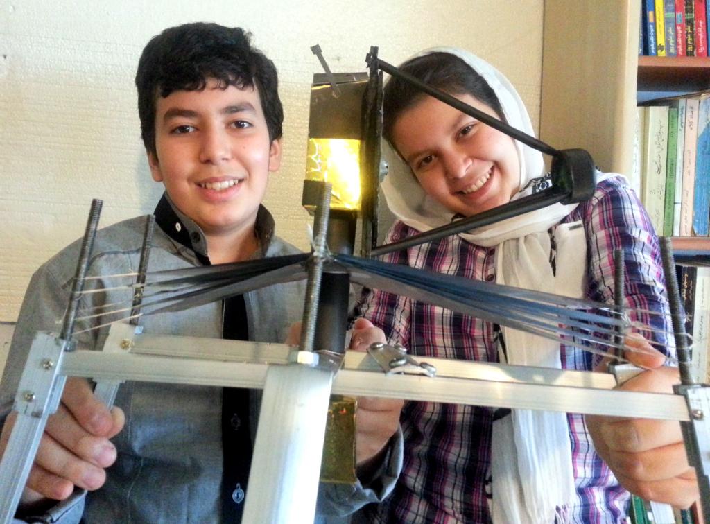 Alireza Setayesh Mehr (on left) and Kimiya Setayesh Mehr (on right) from Karaj, Persia, smile with their Webb model.