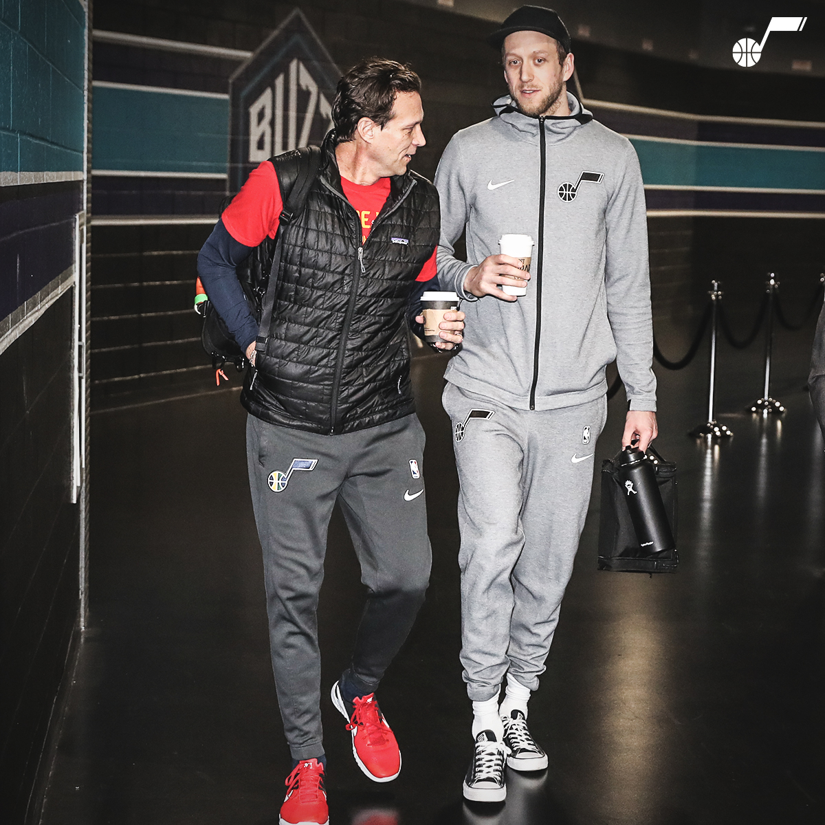 Here's Joe holding a cup of coffee in sweats with Coach.