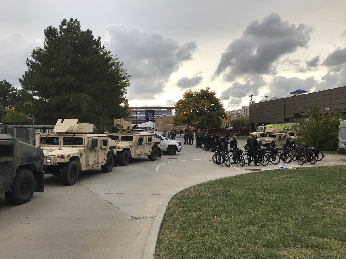 Ohio National Guard and Ohio state troopers on site three hours before presidential debate to begin in Cleveland. Debate to be held inside pavilion in background.