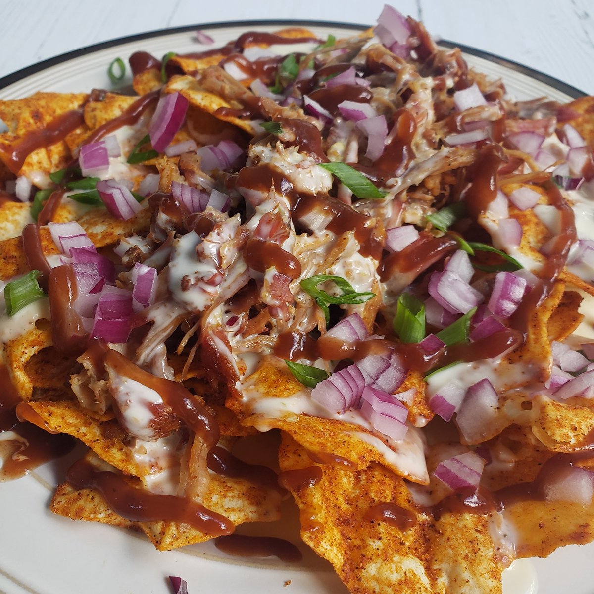 🤠 Redneck Nachos 🤠

Our local Moe's BBQ introduced us to something called Redneck Nachos and they're so good! We decided to ketofy them by using <a href="/QuestNutrition/">Quest Nutrition</a> BBQ Protein Chips, Applewood smoked pulled pork, G Hughes Hickory BBQ sauce, queso, green onion, and red onion. #keto