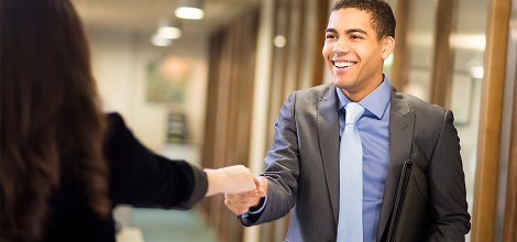 man dressed up shaking hands
