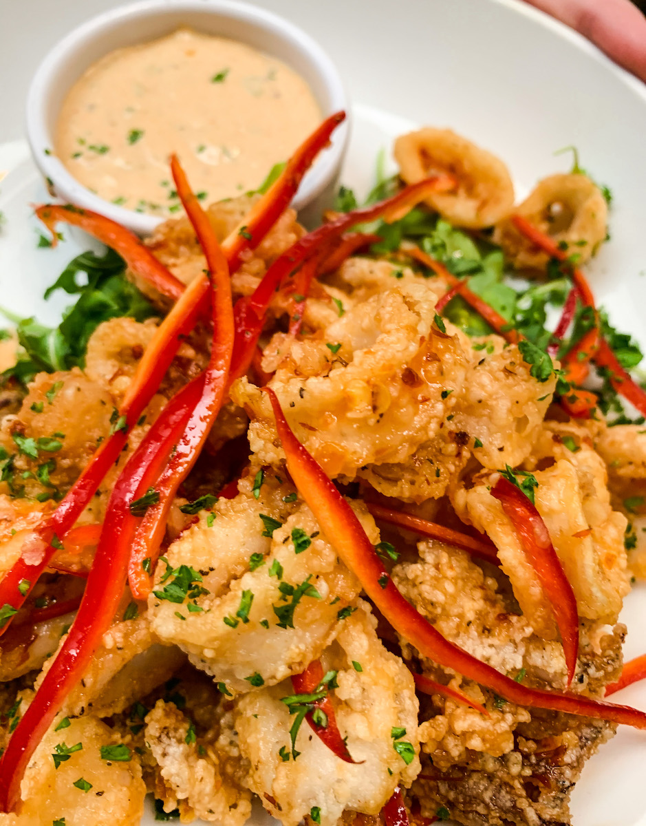 Salt &amp; Pepper Calamari with fresno chilies, arugula, nuoc cham. 
 
Available for dining-in or pickup orders and delivery. Visit brixtavern.com