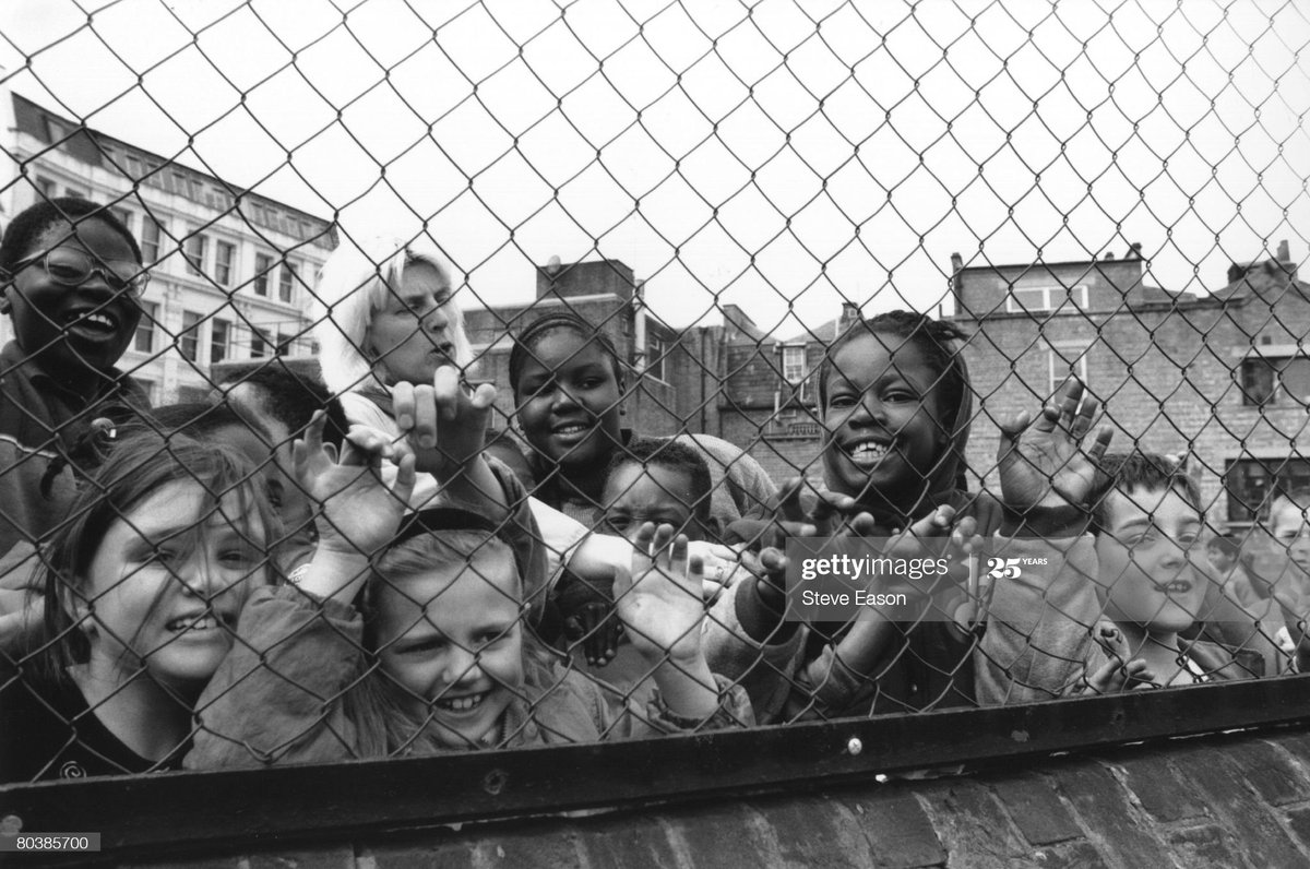 No one is born racist .School pupils clamour for the photographer& #39;s attention in their playground, UK, 29th March 1993. Photo by Steve Eason