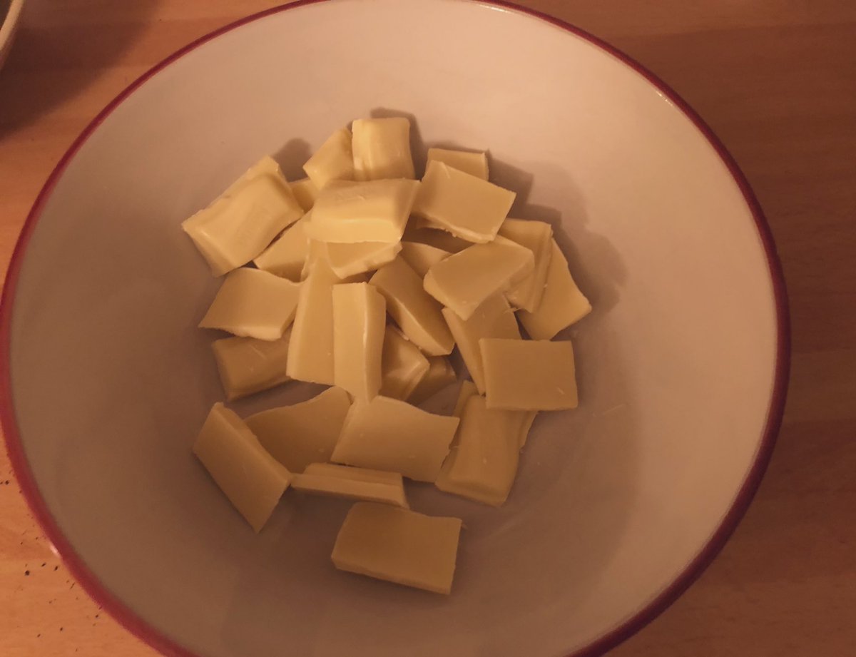 heating cream in a small pan until hot and then pouring it over white chocolate to make ganachewhite chocolate ganache often goes a bit yellow but in this case, it's an advantage because it's for making the moon (traditionally an almost orange salted yolk)