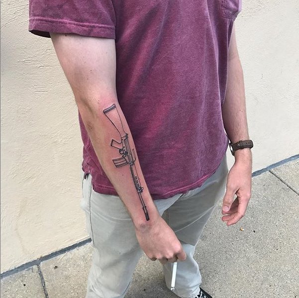 Colton likes Rhodesia. A lot. He likes Rhodesia so much he spray painted his FN-FAL (the service gun of the Rhodesian military) the trademark Rhodesian “baby poop” camo. He also got a tattoo of the FN-FAL on his right forearm.