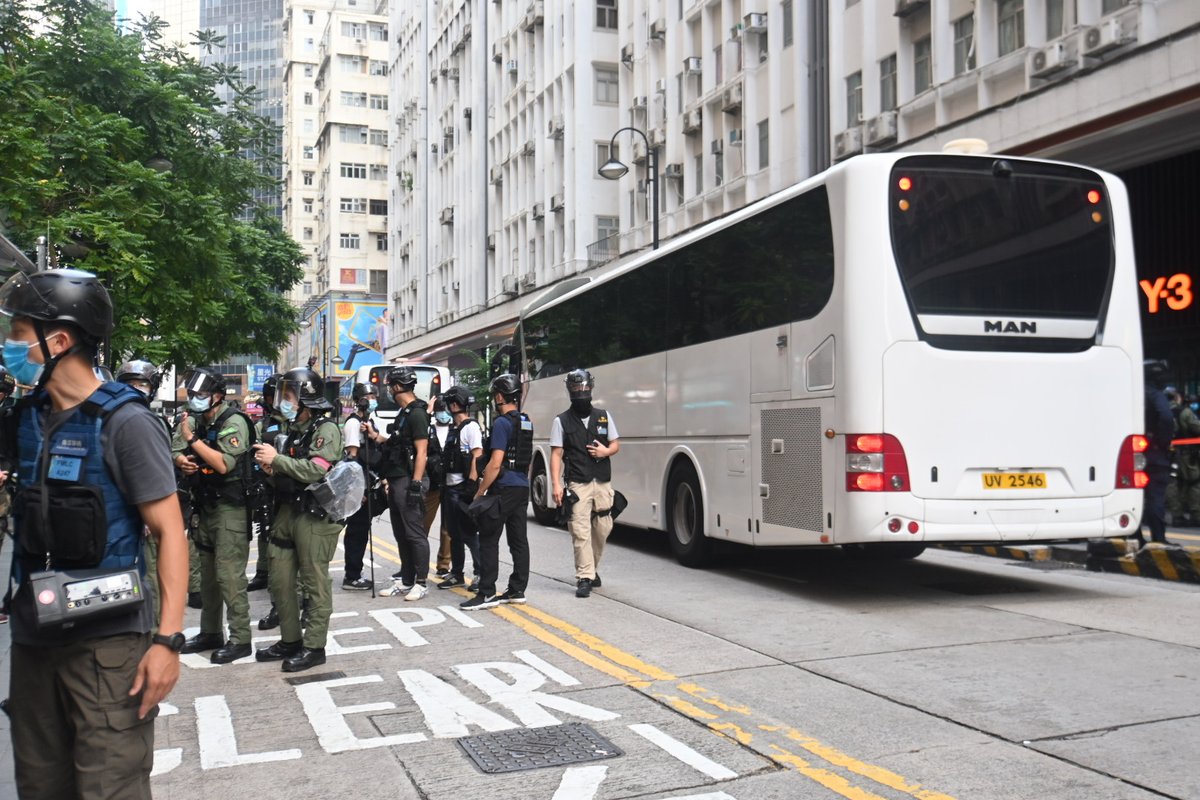 Two large white charter buses have entered the cordon zone, likely to take those currently detained away.